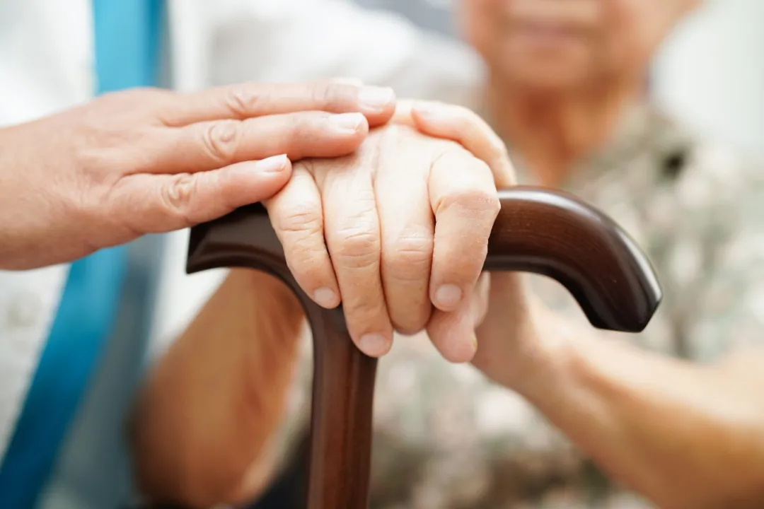 An elderly person receiving supportive care — early detection of Alzheimer's risk enables timely intervention and better quality of life