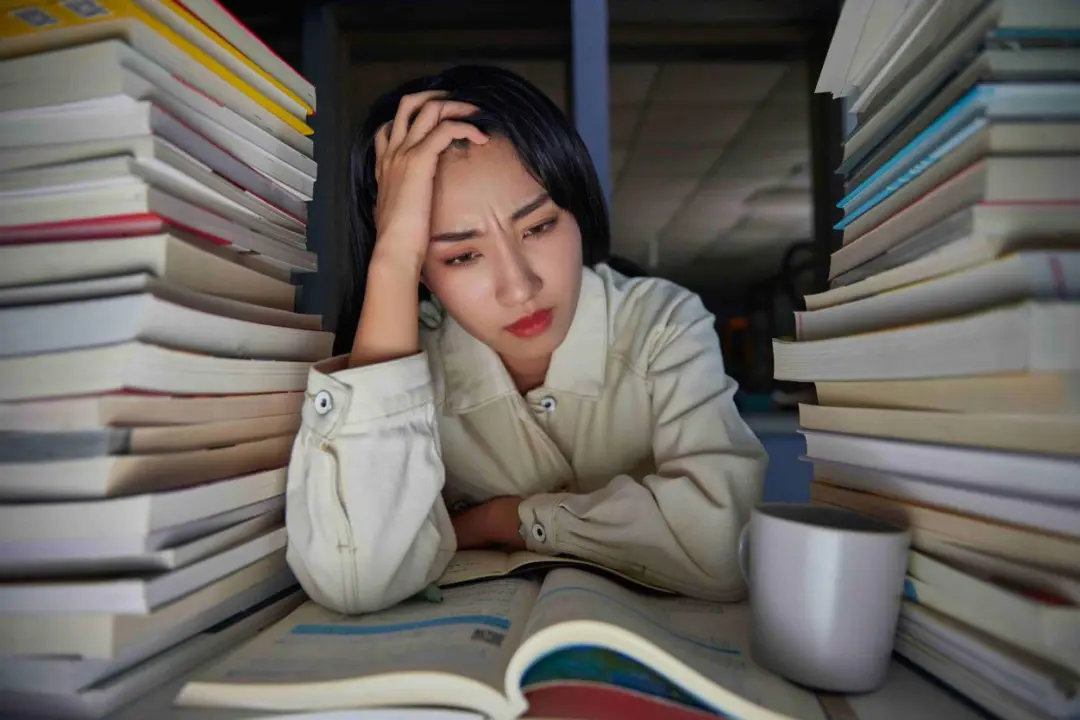A stressed person surrounded by work and study pressure - representing the impact of chronic stress on weight